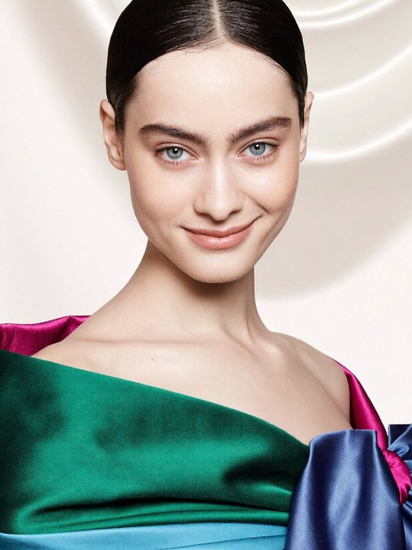 Woman draped in her season's jewel tones, glowing